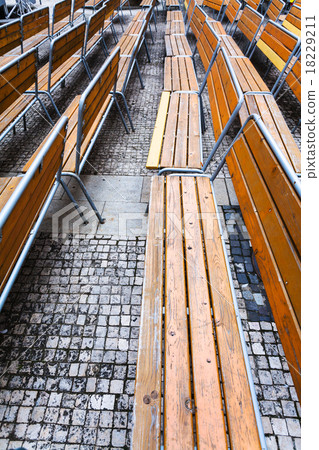 empty wooden benches on urban square in autumn empty wooden benches on urban square in autumn 18229211