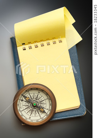 Vintage compass and blank yellow notepad 18233345