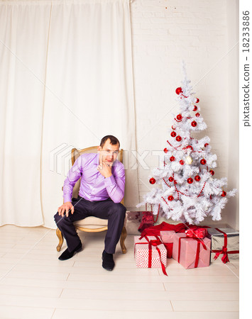 man with Christmas tree at home 18233886