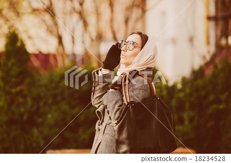 Happy young beautiful girl posing in the park Happy young beautiful girl posing in the park 18234528