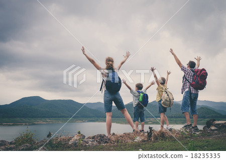 Happy family standing near the lake. 18235335