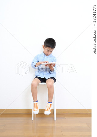 Children looking tablet seriously 18241775
