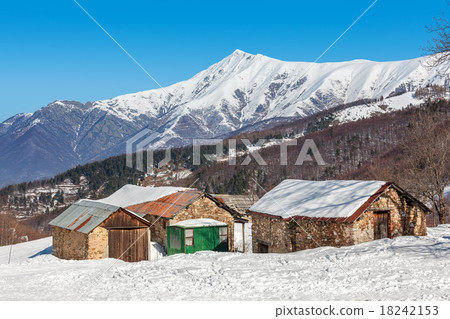Rural houses and snowy mountains in Italy. 18242153
