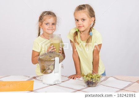 Girls holding a large glass of juice squeezed 18242891