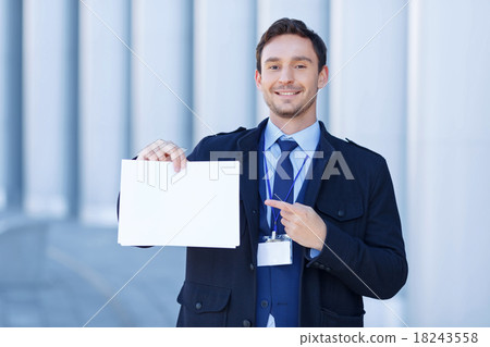 Smiling reporter points at sheet of paper. Smiling reporter points at sheet of paper. 18243558