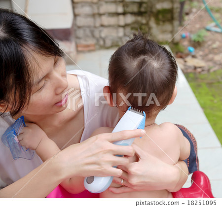Mother cutting baby hair by hair clipper Mother cutting baby hair by hair clipper 18251095