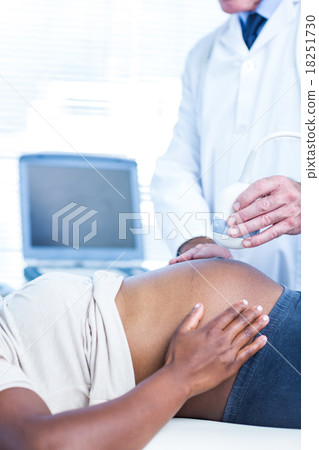 Doctor performing ultrasound on pregnant woman Doctor performing ultrasound on pregnant woman 18251730