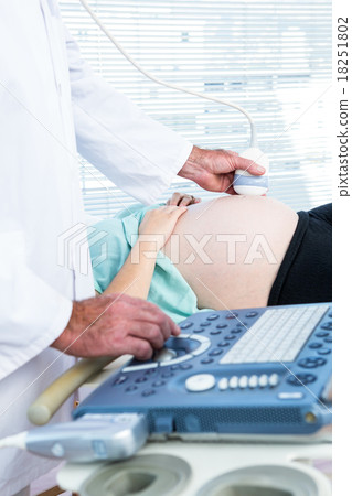 Male doctor doing ultrasound on pregnant woman Male doctor doing ultrasound on pregnant woman 18251802