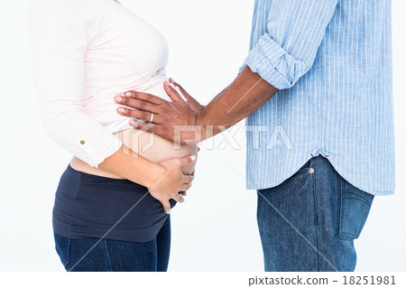 Man touching belly against white background Man touching belly against white background 18251981