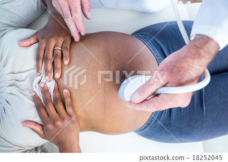 Overhead view of doctor doctor performing ultrasound 18252045