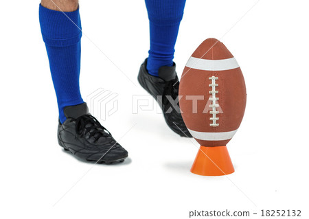 American football player about to kick ball American football player about to kick ball 18252132