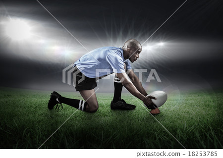 Composite image of rugby player keeping ball on kicking tee 18253785