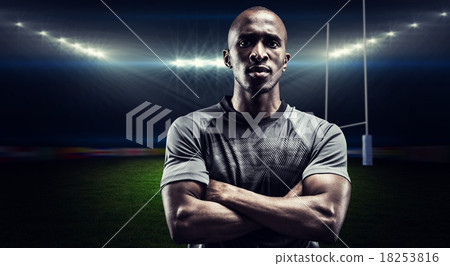 Composite image of portrait of confident rugby player with arms 18253816