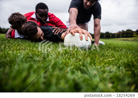 Rugby players tackling during game 18254269