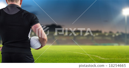 Composite image of rugby player holding the ball 18254665