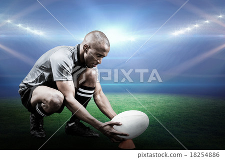 Composite image of rugby player keeping ball on kicking tee 18254886