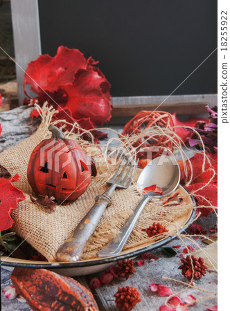 pumpkin on a background of dry plants and candles 18255922