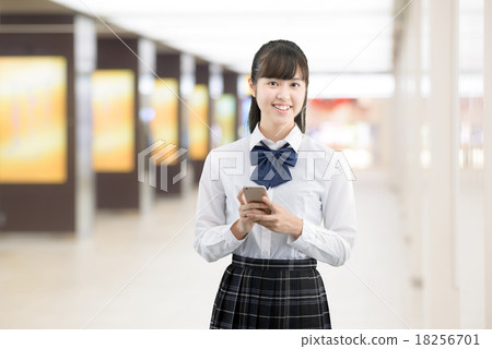 School girls in school uniforms who are meeting at the station 18256701