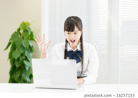 School girls in uniform in front of a white table 18257155