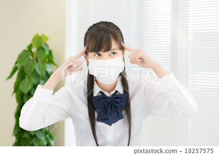 School girls in uniform in front of a white table 18257575