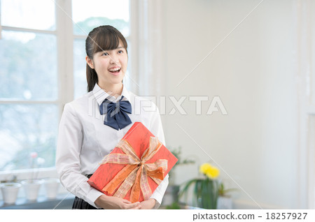 School girls in uniform with their presents in the kitchen 18257927