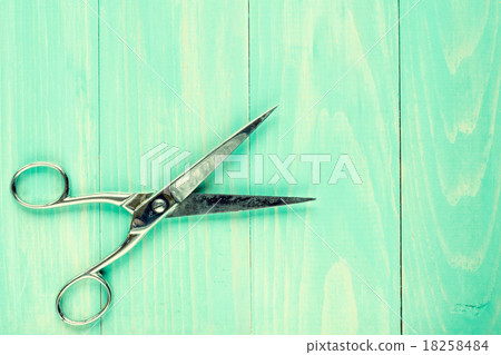 Old scissors on a wooden work table 18258484