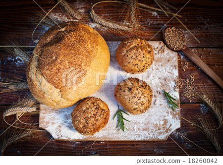 fresh bread and wheat on the wooden table fresh bread and wheat on the wooden table 18260042