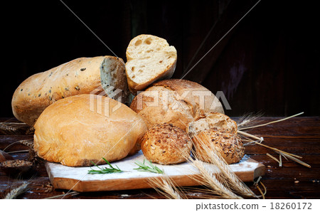 fresh bread and wheat on the wooden table 18260172