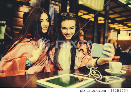 two close friends make selfie in the cafe two close friends make selfie in the cafe 18261964