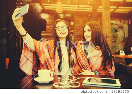 two close friends make selfie in the cafe two close friends make selfie in the cafe 18261970