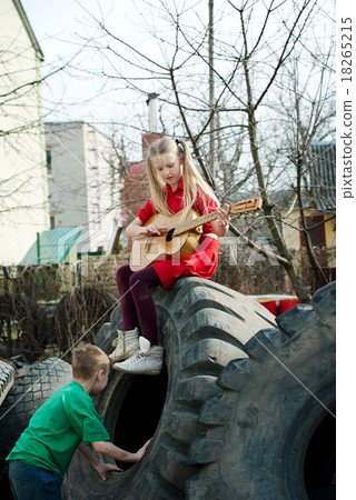 children playing in junkyard tires children playing in junkyard tires 18265215