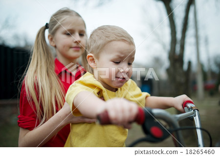 children ride on bicycle in yard children ride on bicycle in yard 18265460