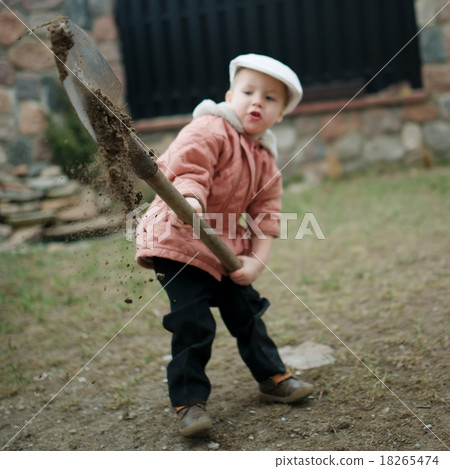little boy digging a hole little boy digging a hole 18265474