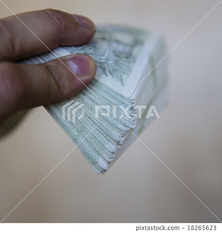 pack of money - big pile of banknotes in hand 18265623