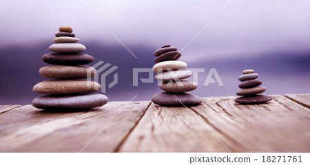 Zen Balancing Pebbles Next to a Misty Lake Concept 18271761