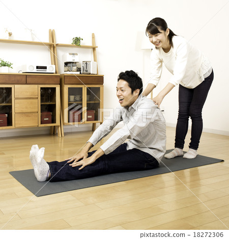 Two people stretch at home Two people stretch at home 18272306