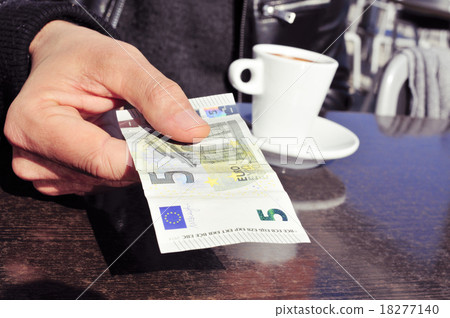 young man paying the bill in the terrace of a cafe young man paying the bill in the terrace of a cafe 18277140