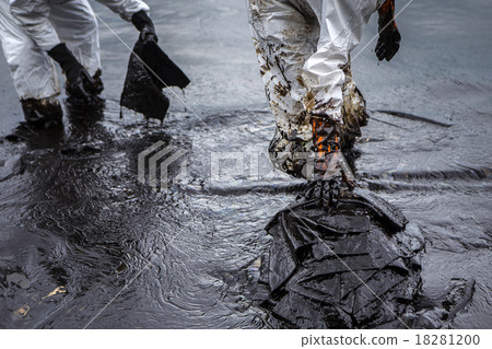 Workers remove crude oil from a beach Workers remove crude oil from a beach 18281200