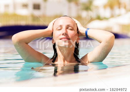 Young woman enjoying swimming pool Young woman enjoying swimming pool 18284972