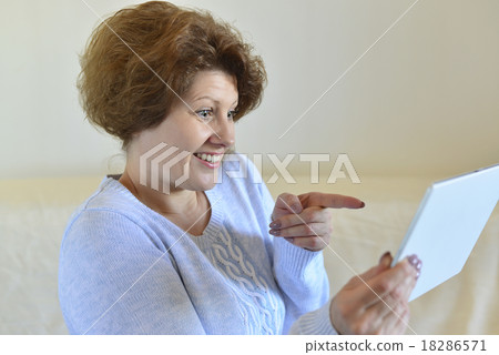 woman in amazement looking at tablet computer woman in amazement looking at tablet computer 18286571