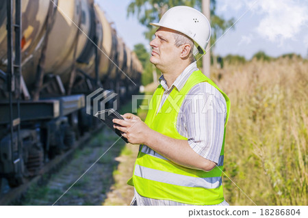 Railway Engineer using tablet PC on railway near f Railway Engineer using tablet PC on railway near f 18286804