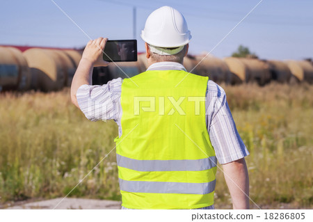 Railway Engineer filmed with tablet PC near freigh 18286805