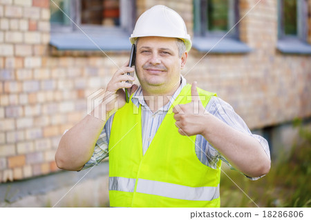 Engineer showing thumb up near the building Engineer showing thumb up near the building 18286806