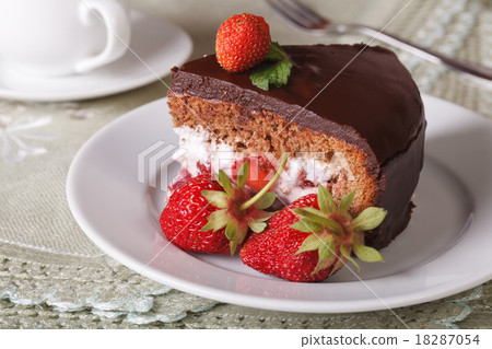 piece of chocolate cake with strawberries closeup 18287054