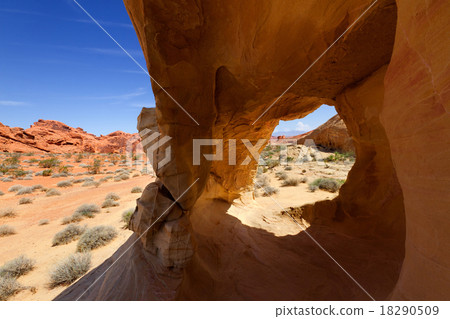 Desert Landscape Framed by Rock Formation Desert Landscape Framed by Rock Formation 18290509