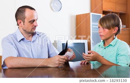 Father giving cash to teenage son. 18293130