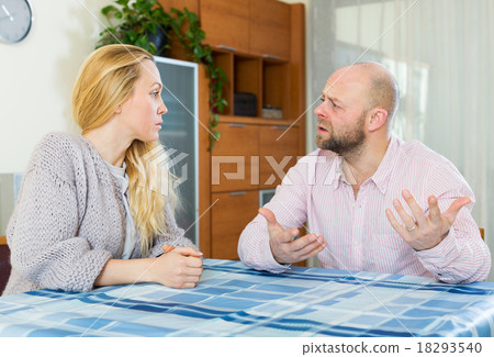 Serious couple talking in home 18293540