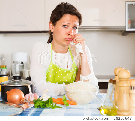 Pensive woman cooks rice with vegetables 18293648