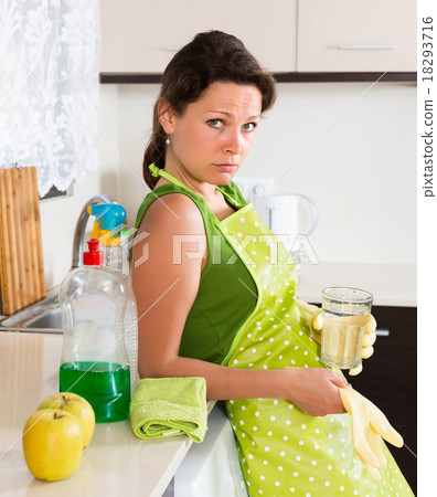 Sad woman cleaning furniture Sad woman cleaning furniture 18293716