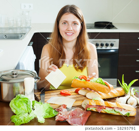 woman cooking spanish sandwiches with cheese 18293791